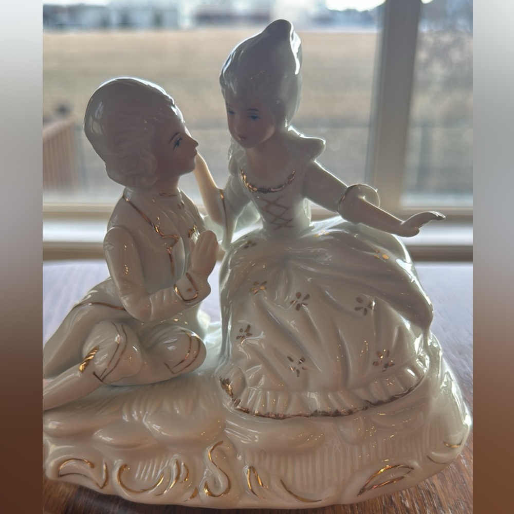 Elegant Porcelain Figurine with Gold Accents that plays music and spins